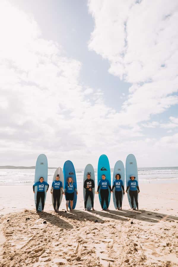 Port Stephen: One Mile Beach Group Surf Lesson - Learning to stand in waist-deep water