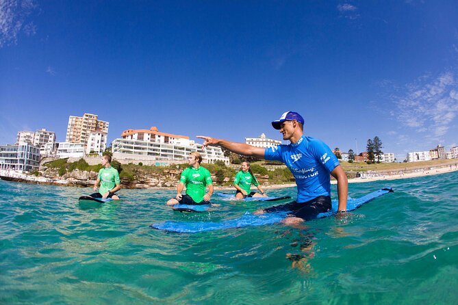 Surfing Lessons on Sydney's Bondi Beach - Entering Bondi’s waves with an instructor nearby