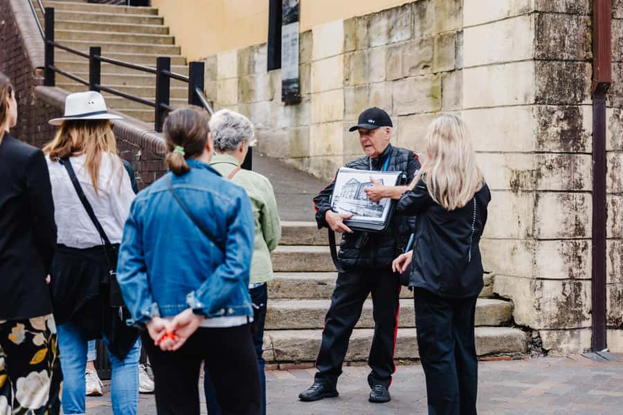 Sydney: The Rocks & Sydney Harbour Guided Walking Tour - Entering The Rocks through sandstone lanes